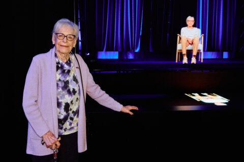 Eine Person, die vor einer Bühne steht.