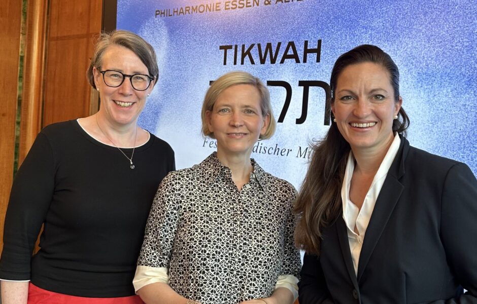 Three Women in front of a Screen.